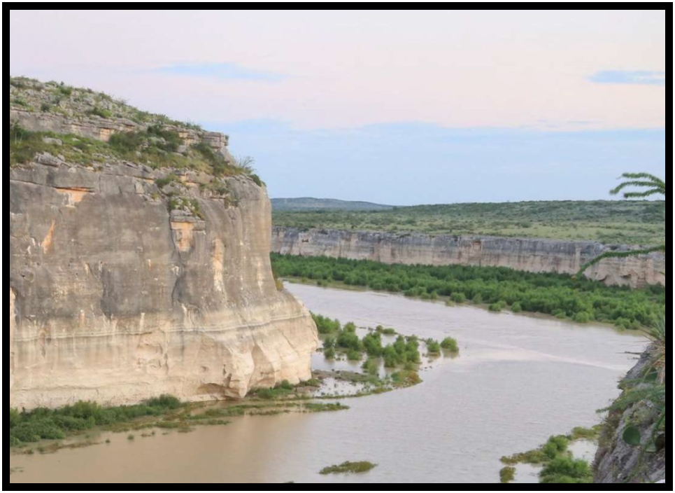 A river bends around some cliffs