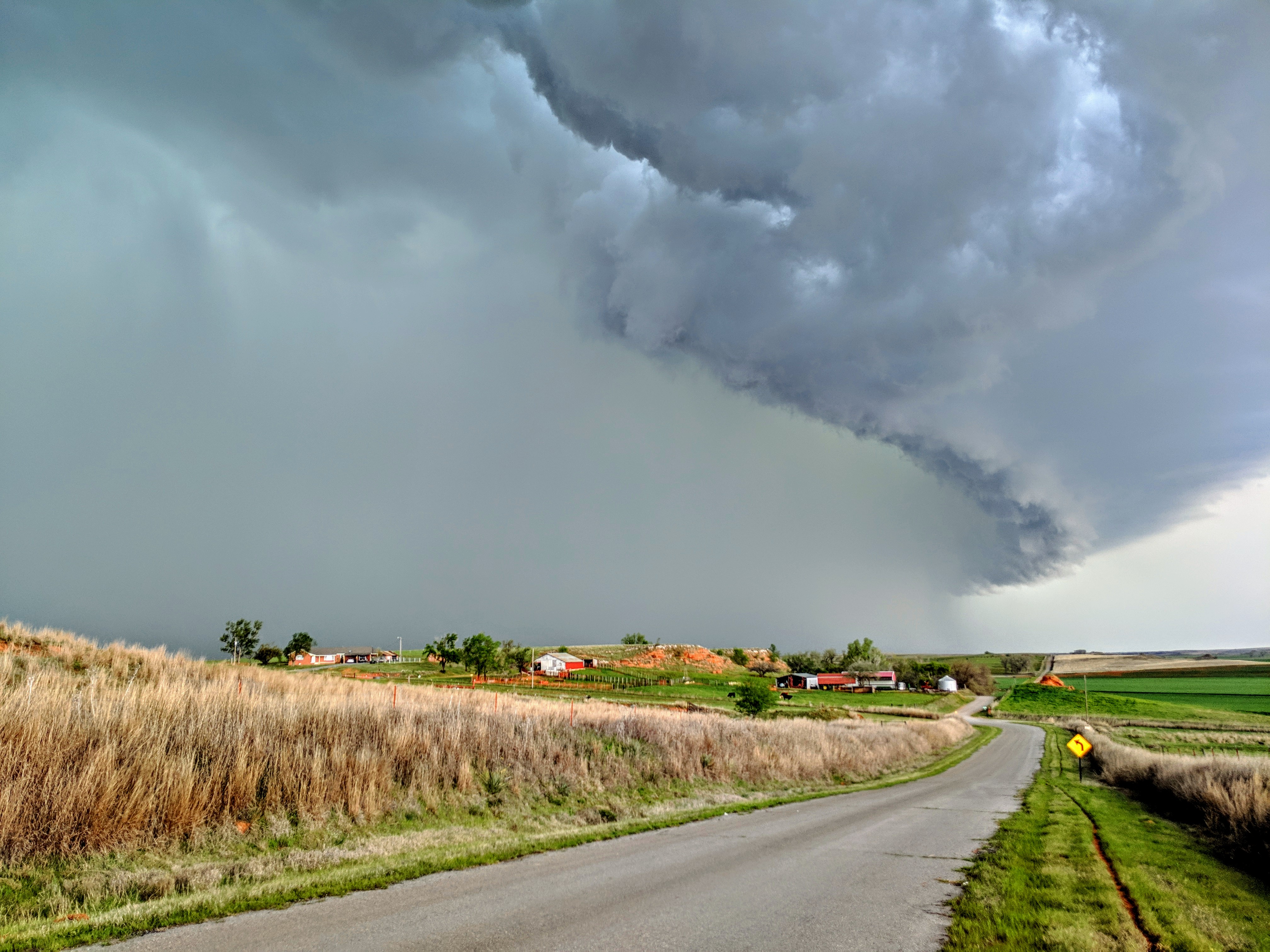 A stormy sky over a farmstead