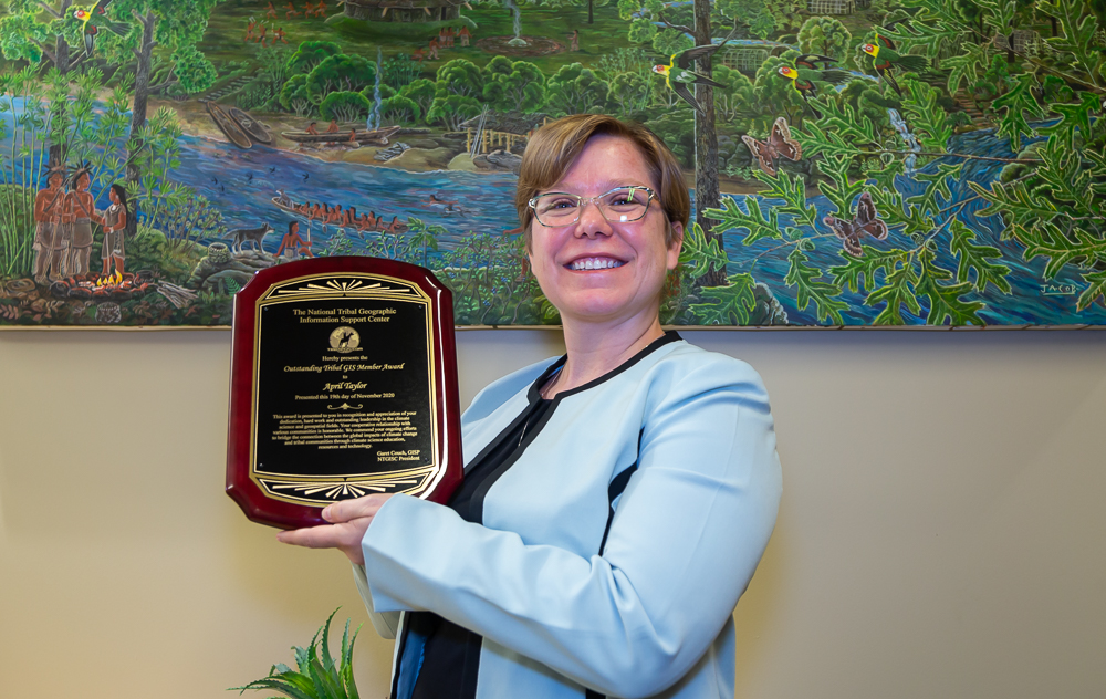 April Taylor holding her Outstanding Tribal GIS Member Award