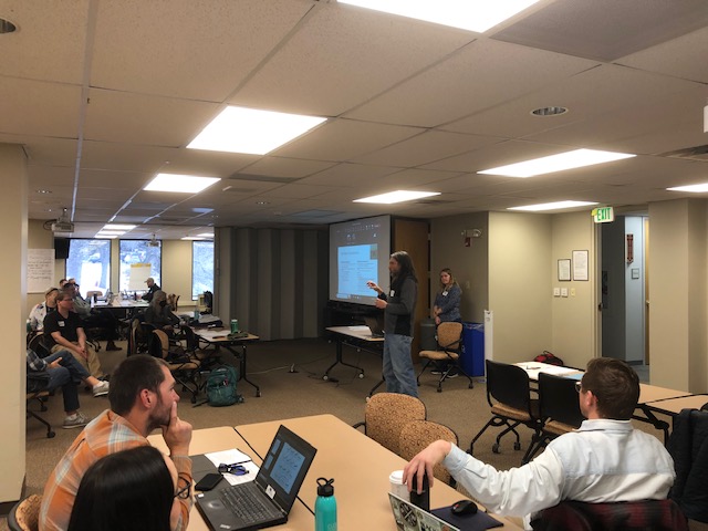 A speaker talks to workshop participants