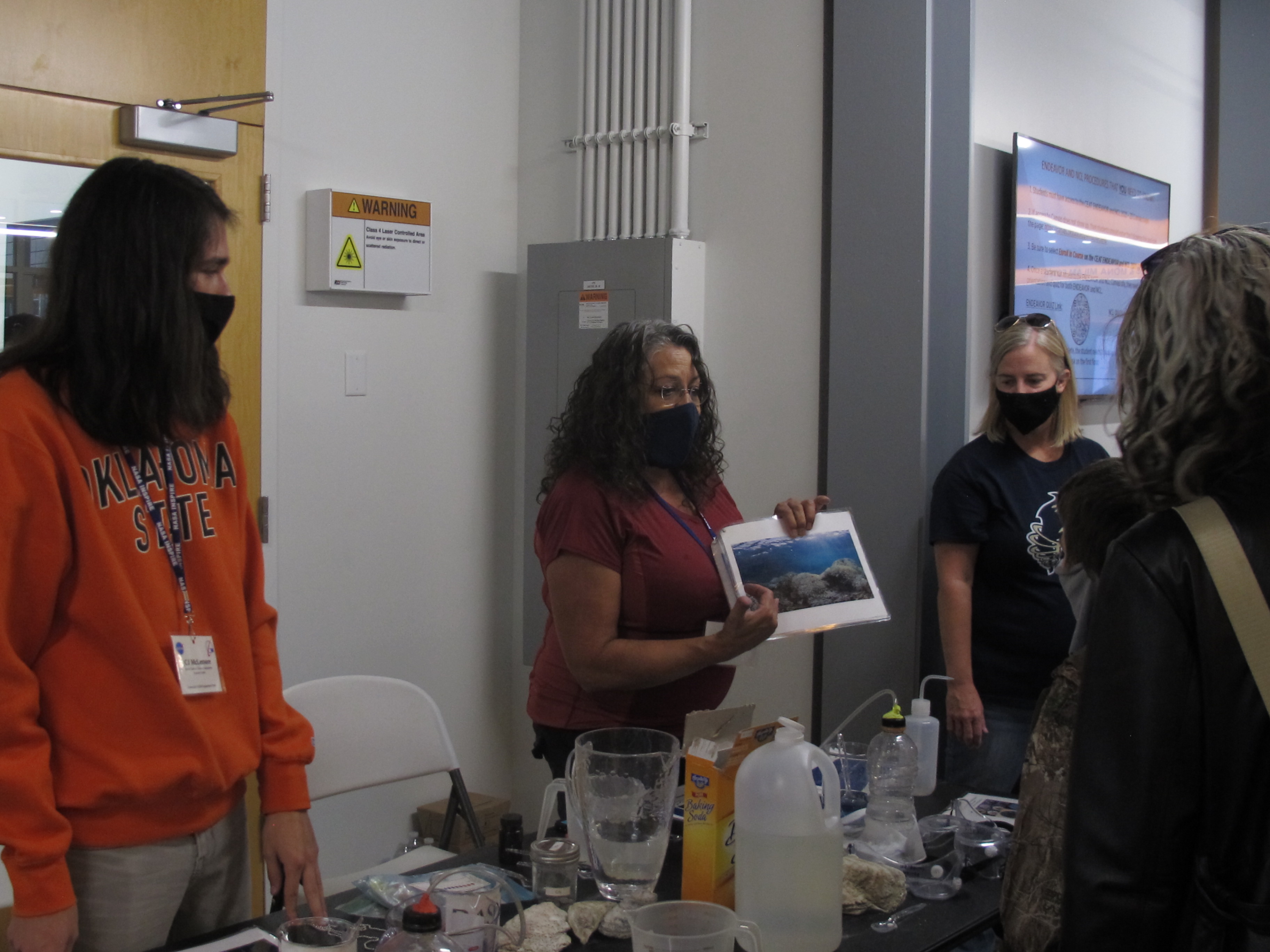 Two people explain the importance of this experiment to onlookers