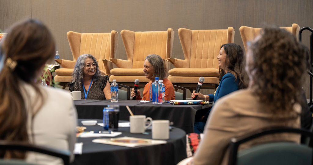 A group of speakers laughing